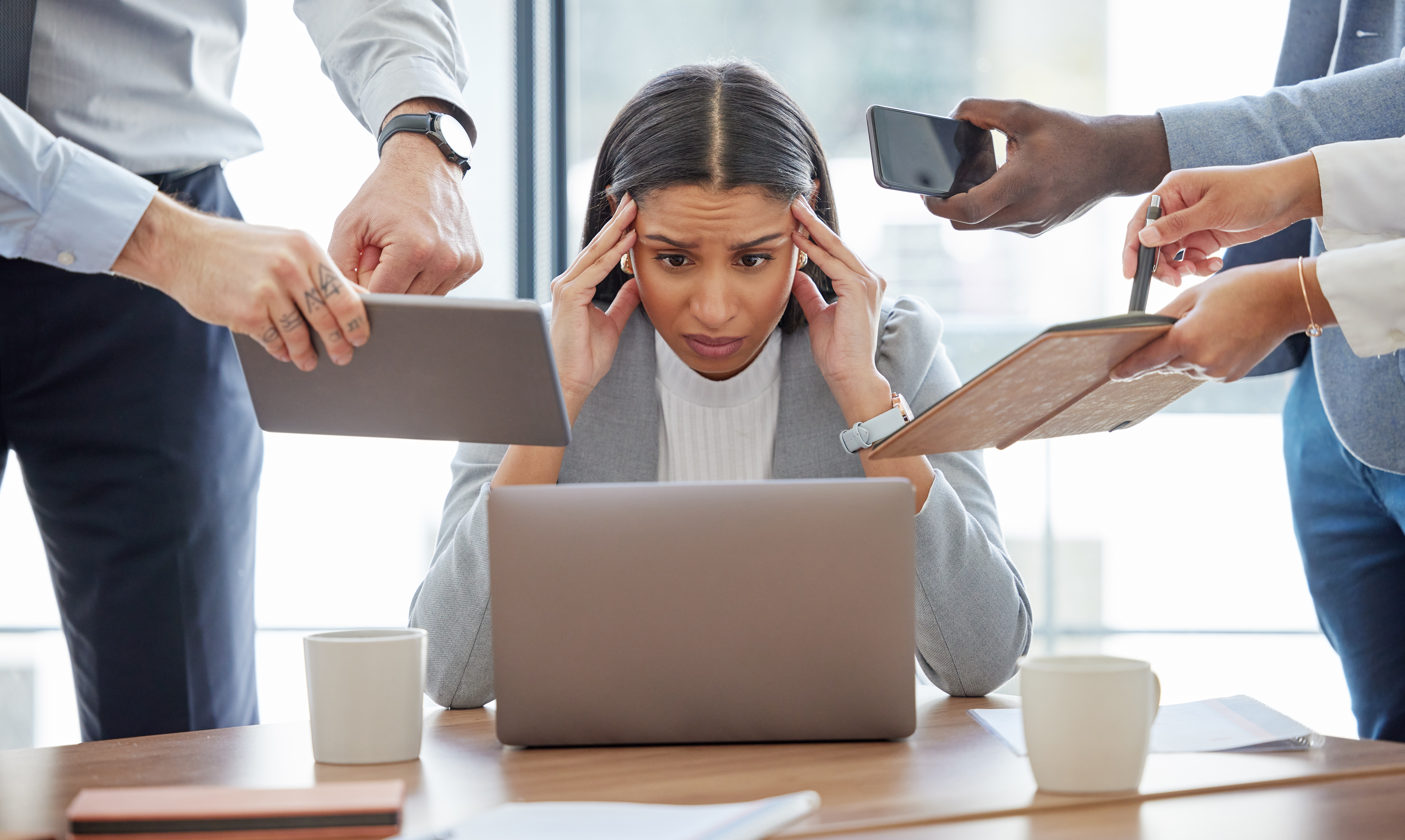 A professional woman showing signs of stress and work burnout.