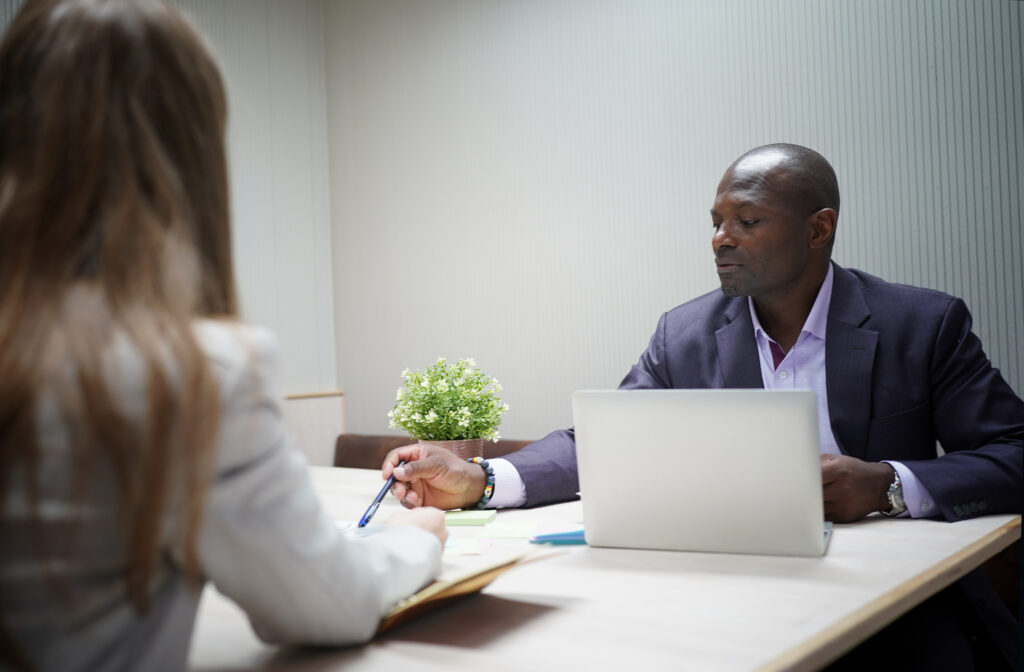 Two professionals having a conversation, addressing Synaptic Inc MLM questions