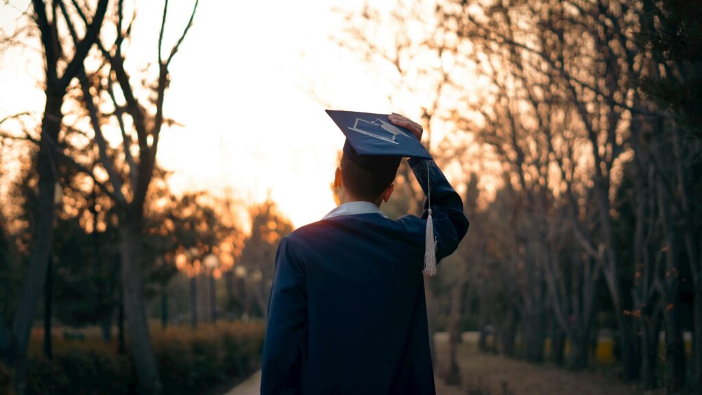 A new grad facing the sunset sky
